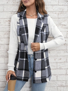 Detailed close-up of plaid vest featuring single-breasted black buttons and woven texture