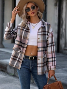 Detailed close-up of a women's red plaid thick shirt jacket with breast pockets and tortoiseshell buttons
