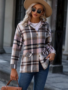 Detail of wooden buttons and plaid pattern on women's pink checkered shirt jacket