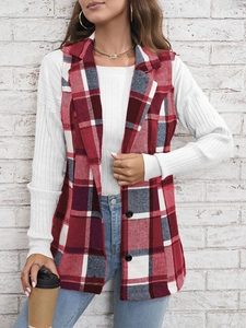 Close-up of red and white plaid vest featuring black buttons and classic lapel texture