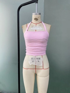 Detail of pink halter top showing high-elasticity textured horizontal pleated fabric
