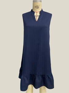Detail of dark blue sleeveless dress showing V-neckline and textured vertical stripe fabric