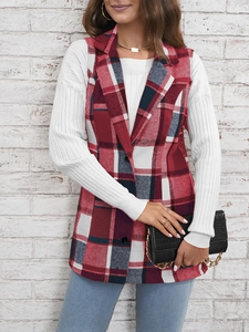 Detail of red plaid vest with notch lapel worn over a white long sleeve ribbed top
