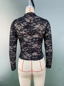 Detail of sheer black lace top with rose floral pattern and mock neck on mannequin