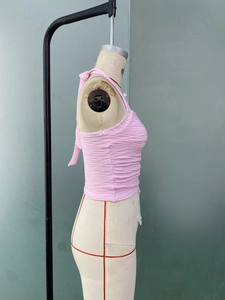 Detail showing the textured pink halter neck top with pleated ripple fabric on mannequin