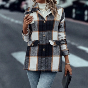 Close-up of red plaid shacket with front flap pockets and classic button-down collar
