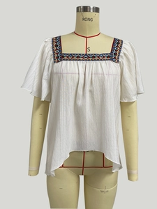Close-up of square neck white cotton top with colorful geometric ethnic embroidery