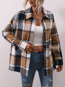 Detail shot of a plaid flannel jacket featuring large buttons and spacious front patch pockets