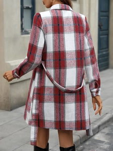 Detail of red and black plaid dress with adjustable waist belt and classic long sleeves