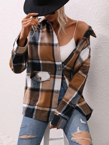 Detail shot of heavy brown plaid cardigan featuring classic collar and buttoned chest pocket