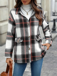 Detail shot of red and black plaid oversized shirt jacket with chest pockets on street