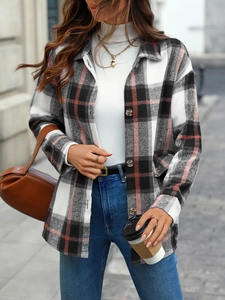 Detail of red and black plaid flannel jacket with textured buttons and wool-like fabric