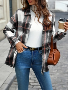 Detail shot of the vintage red plaid flannel texture and button-up front on a thick shacket