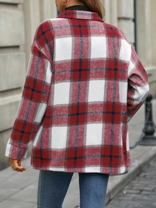 Detail of red and white plaid shacket with dropped shoulder and thick wool-like fabric