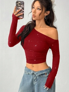 Close-up of red off-shoulder long sleeve top with shimmering sequins and ribbed knit texture