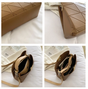 Detail view of the quilted geometric handbag interior storage and reinforced bottom stitching