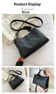 Detail of black geometric quilted tote bag with adjustable shoulder strap and zipper closure