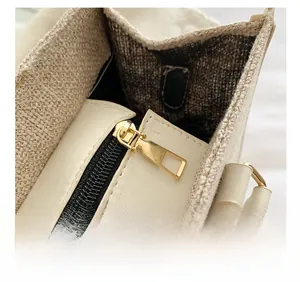 Close-up of smooth gold zipper and durable canvas texture on a large tote bag