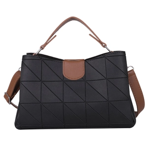 Chic black quilted crossbody bucket bag with brown handles and silver metal hardware