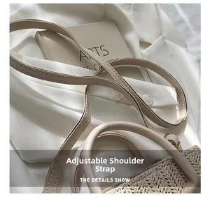 Detail showing the adjustable leather shoulder strap and woven texture of the handbag