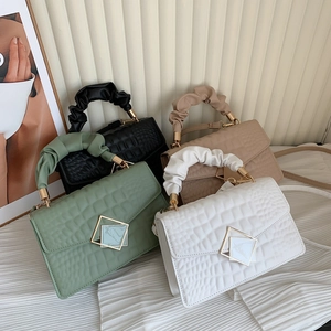 Crocodile pattern crossbody bags with cloud handles in green, black, cream and beige