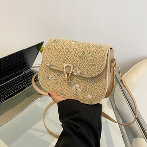 Floral embroidered straw crossbody bag with faux leather trim and gold metal clasp
