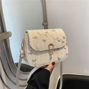 Chic beige woven straw handbag with floral embroidery and gold horseshoe metal clasp