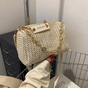 Summer woven crossbody pillow bag with gold floral chain and white leather details