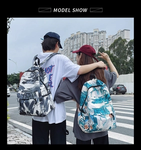 Street style backpacks with graffiti prints shown on models in an urban setting