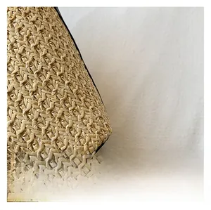 Close-up of the high-quality natural straw woven texture and intricate cross-stitch patterns