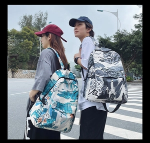 Detail shot of large graffiti print backpacks for couples in outdoor street setting