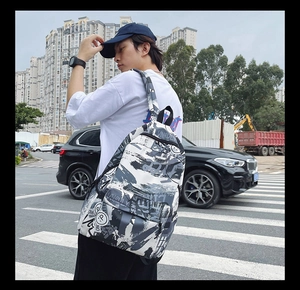 Street style backpack with abstract graffiti print shown from a side-view on a model