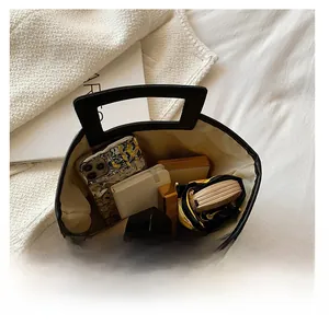 Top view of large woven tote bag showing internal storage for phone and notebook