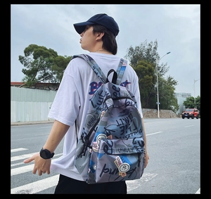 Street style backpack with graffiti print showing outdoor usage and strap details