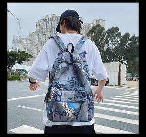 Detail of urban graffiti print backpack with multiple zip pockets in grey-blue camouflage
