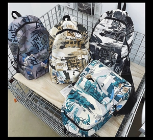 Close-up of four trendy graffiti backpacks with street style letter prints and smiley patterns