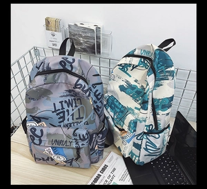 Detailed view of urban graffiti style backpacks in grey-purple and beige waterproof fabric