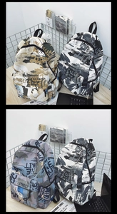 Detail of multi-color graffiti canvas backpacks with abstract letters on a wooden desk