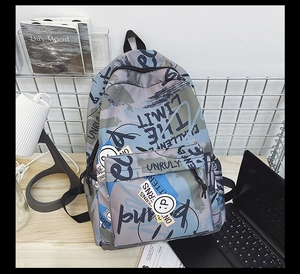 Close-up of graffiti waterproof nylon backpack featuring abstract blue and green patterns