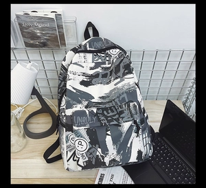 Detail view of graffiti pattern and Unruly text on casual large capacity backpack