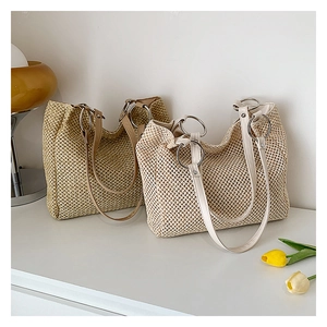 Close-up of woven straw tote bags showing mesh texture and faux leather shoulder straps