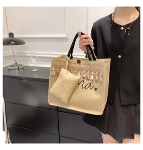 Detail of jute tote bag featuring colorful tassels and black Ma heart lettering design
