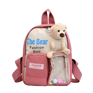Zaino per bambini rosa e beige con orsetto di peluche e tasca trasparente con pompon colorati