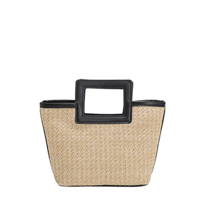 Large woven tote bag with black leather rectangular handles and natural straw texture