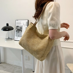 Minimalist straw hobo tote bag with leather shoulder strap for summer beach or commute