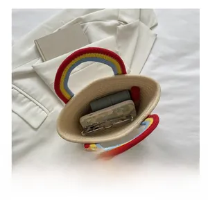 Top view of handmade woven straw bag with rainbow handles showing daily storage capacity