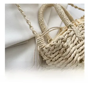 Close-up of handmade straw bucket bag showing intricate woven texture and drawstring liner