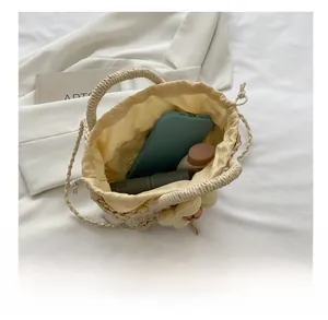 Top view of woven bucket bag showing capacity for phone, lipstick, and cosmetics