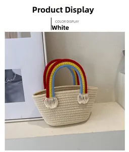 Detailed shot of a cream woven tote bag featuring a colorful rainbow handle and tassels