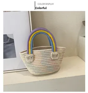 Detail of hand-woven rainbow handbag with colorful stitching and tri-color arched handle